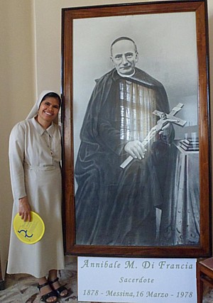 Sister beside portrait of St Annibale